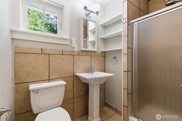 761 Chuckanut Dr, Bellingham, WA 98229 - bathroom featuring a shower stall, toilet, tile patterned flooring, a sink, and tile walls