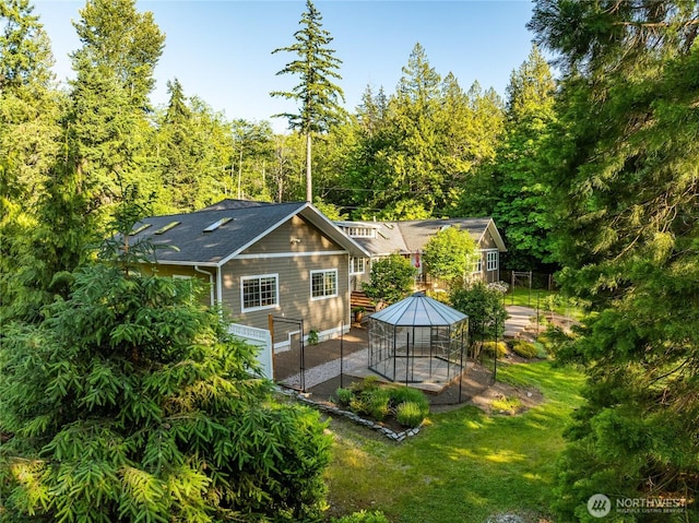 761 Chuckanut Dr, Bellingham, WA 98229 - rear view of house with a patio, a lawn, and a wooded view