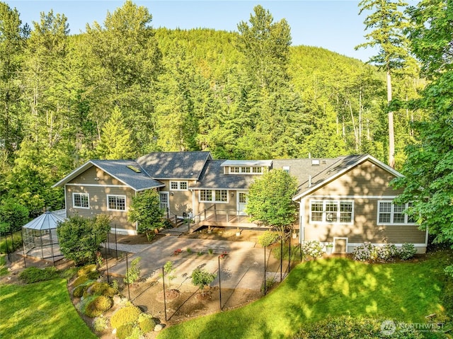 761 Chuckanut Dr, Bellingham, WA 98229 - rear view of property with a wooded view, a wooden deck, a patio, and a yard