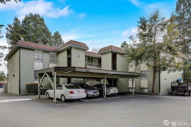 18904 8th Ave NW Unit 128, Shoreline, WA 98177 - view of front of property featuring covered parking, mansard roof, and a shingled roof