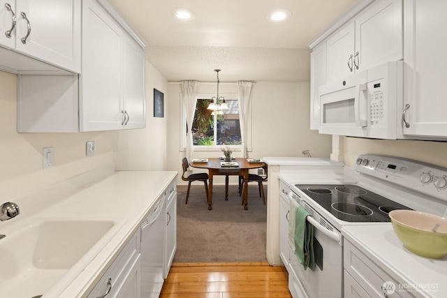 18904 8th Ave NW Unit 128, Shoreline, WA 98177 - kitchen featuring white appliances, white cabinetry, and recessed lighting