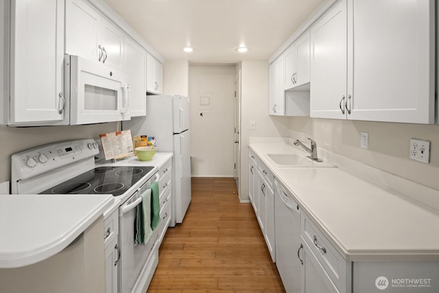 18904 8th Ave NW Unit 128, Shoreline, WA 98177 - kitchen with white appliances, light wood-style floors, recessed lighting, light countertops, and white cabinets