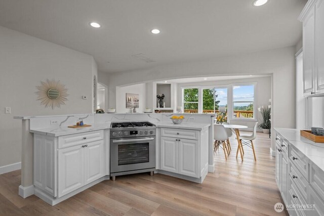 9304 S 223rd Pl, Kent, WA 98031 - kitchen featuring high end stove, white cabinets, recessed lighting, light wood-style flooring, and light stone countertops
