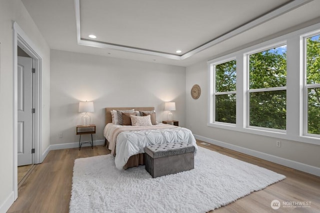 9304 S 223rd Pl, Kent, WA 98031 - bedroom with multiple windows, wood finished floors, baseboards, recessed lighting, and a tray ceiling