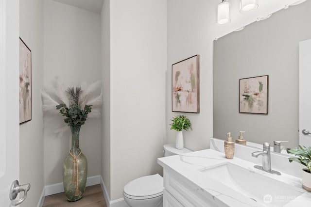 9304 S 223rd Pl, Kent, WA 98031 - half bath featuring toilet, vanity, wood finished floors, and baseboards