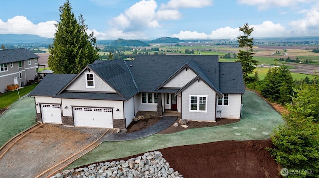 7514 Avalon Heights Way, Sedro Woolley, WA 98284 - view of front of home featuring dirt driveway, a garage, stone siding, and a front yard
