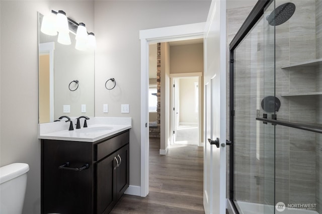 7514 Avalon Heights Way, Sedro Woolley, WA 98284 - bathroom featuring vanity, wood finished floors, a stall shower, toilet, and baseboards