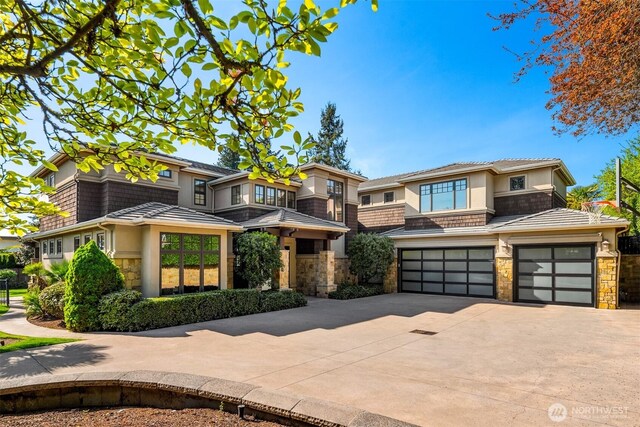 9420 NE 31st St, Clyde Hill, WA 98004 - prairie-style house featuring stone siding, concrete driveway, stucco siding, and an attached garage