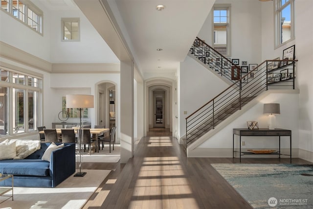 9420 NE 31st St, Clyde Hill, WA 98004 - foyer with a towering ceiling, arched walkways, hardwood / wood-style floors, and stairs