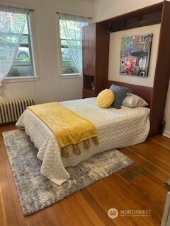 129 Warren Ave N Unit 18, Seattle, WA 98109 - bedroom with radiator, hardwood / wood-style flooring, and multiple windows
