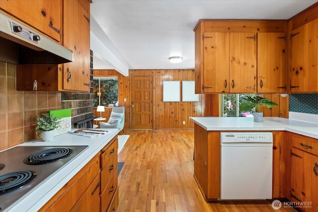 9125 221st St SW, Edmonds, WA 98026 - kitchen featuring stainless steel electric cooktop, brown cabinets, backsplash, and wooden walls
