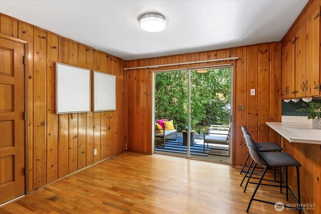 9125 221st St SW, Edmonds, WA 98026 - dining area featuring light wood-type flooring, wooden walls, and baseboards