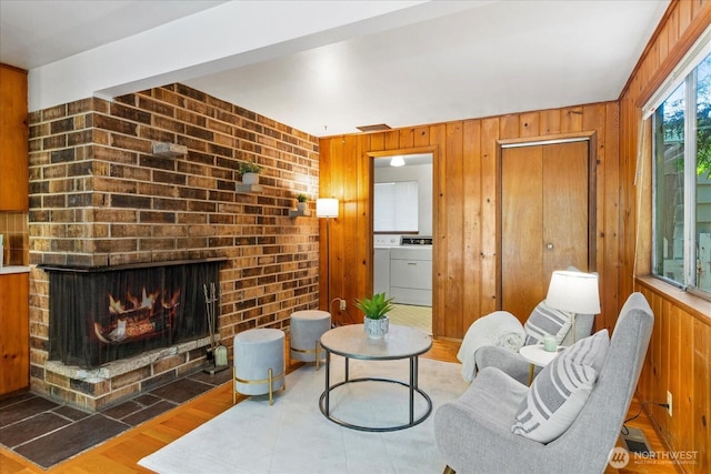 9125 221st St SW, Edmonds, WA 98026 - sitting room with washer / dryer, wooden walls, wood finished floors, and a fireplace