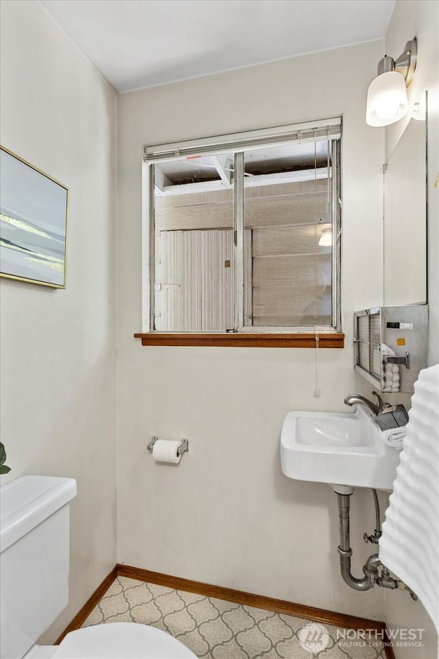 9125 221st St SW, Edmonds, WA 98026 - bathroom with toilet, a sink, and baseboards