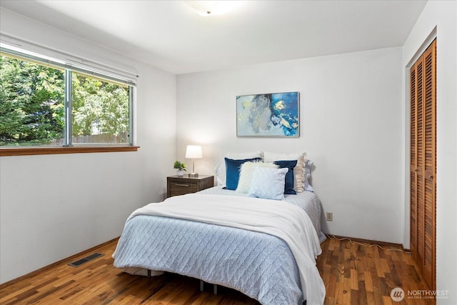 9125 221st St SW, Edmonds, WA 98026 - bedroom featuring wood finished floors, a closet, and baseboards