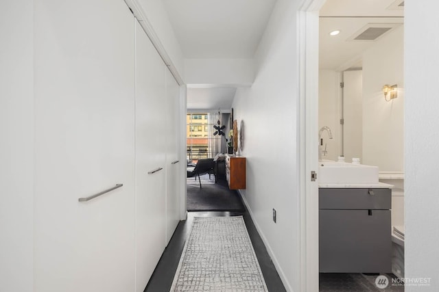 1425 Western Ave Unit L308, Seattle, WA 98101 - hallway with baseboards and dark colored carpet