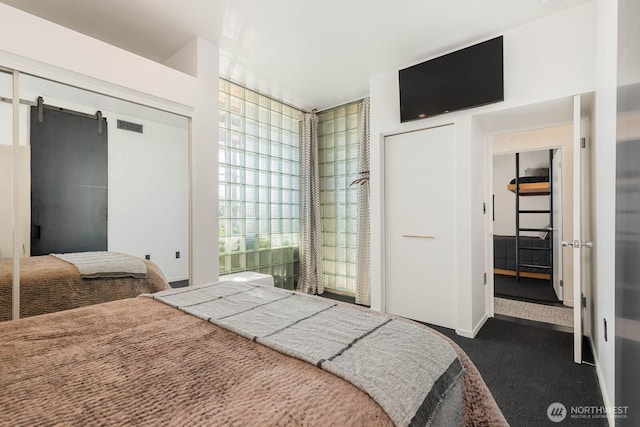 1425 Western Ave Unit L308, Seattle, WA 98101 - bedroom with dark colored carpet and a closet