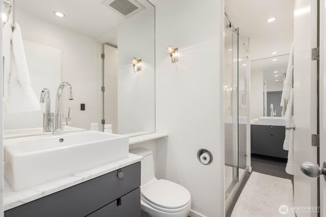 1425 Western Ave Unit L308, Seattle, WA 98101 - bathroom with vanity, a shower stall, toilet, and recessed lighting