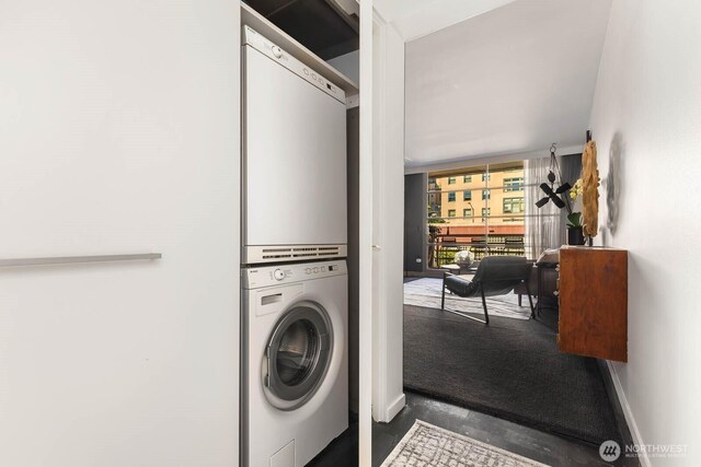 1425 Western Ave Unit L308, Seattle, WA 98101 - washroom with stacked washing machine and dryer and baseboards