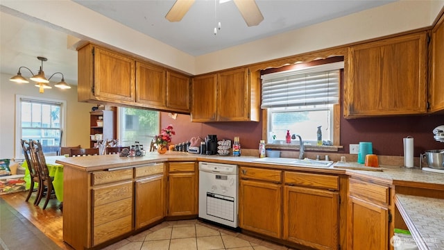 123 NE C St, College Place, WA 99324 - kitchen with white dishwasher, light countertops, a peninsula, and healthy amount of natural light