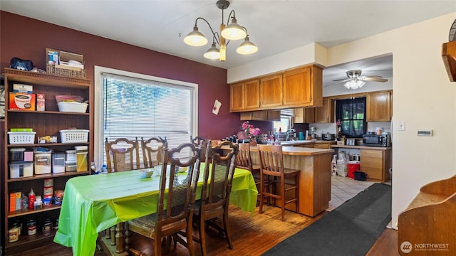 123 NE C St, College Place, WA 99324 - dining area with plenty of natural light, a chandelier, ceiling fan, and wood finished floors