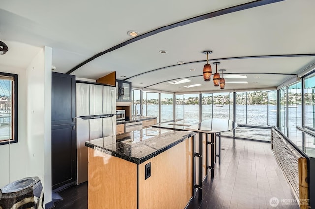 2040 Westlake Ave N Unit 26, Seattle, WA 98109 - kitchen with tile countertops, a water view, a center island, dishwasher, and dark wood finished floors
