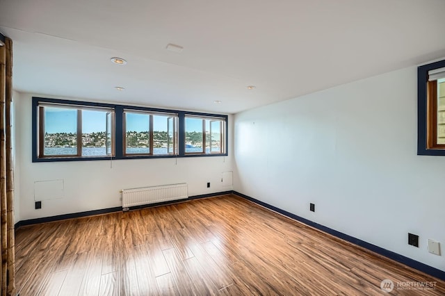 2040 Westlake Ave N Unit 26, Seattle, WA 98109 - empty room featuring radiator and wood finished floors