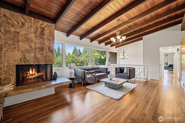 12508 SE 60th St, Bellevue, WA 98006 - living room with wood ceiling, a chandelier, wood finished floors, a tile fireplace, and baseboards