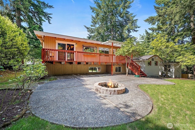 12508 SE 60th St, Bellevue, WA 98006 - back of property featuring a patio, a deck, stairs, a fire pit, and a lawn