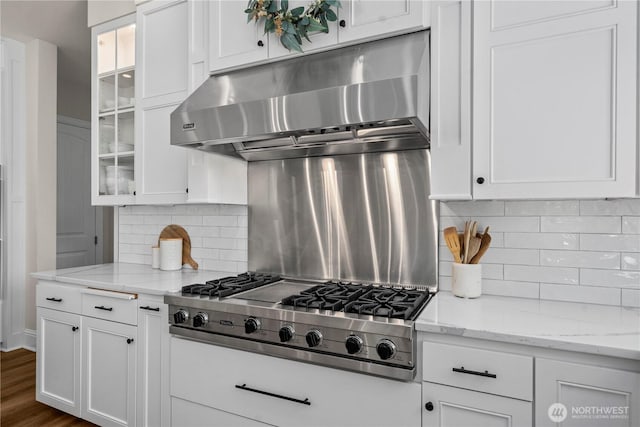 16006 288th St E, Graham, WA 98338 - kitchen with under cabinet range hood, stainless steel gas stovetop, white cabinetry, and glass insert cabinets