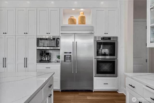 16006 288th St E, Graham, WA 98338 - kitchen featuring appliances with stainless steel finishes, white cabinets, dark wood-style flooring, decorative backsplash, and glass insert cabinets