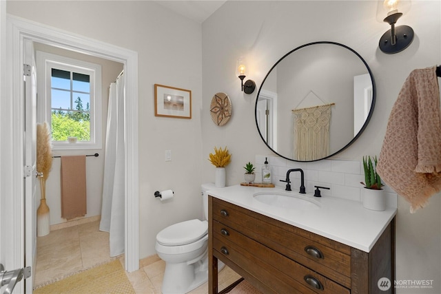 16006 288th St E, Graham, WA 98338 - bathroom with vanity, toilet, tasteful backsplash, tile patterned flooring, and baseboards