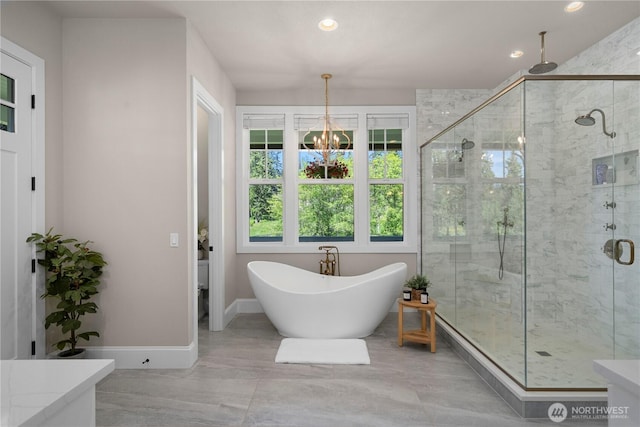 16006 288th St E, Graham, WA 98338 - full bathroom featuring a stall shower, a chandelier, a freestanding tub, recessed lighting, and baseboards