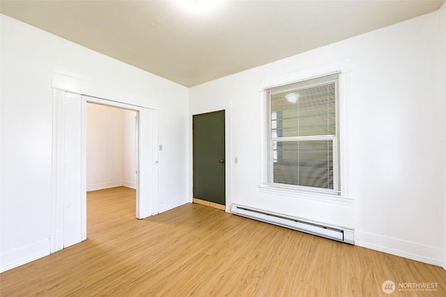 3827 S Morgan St, Seattle, WA 98118 - unfurnished room with a baseboard radiator, light wood-style floors, and baseboards