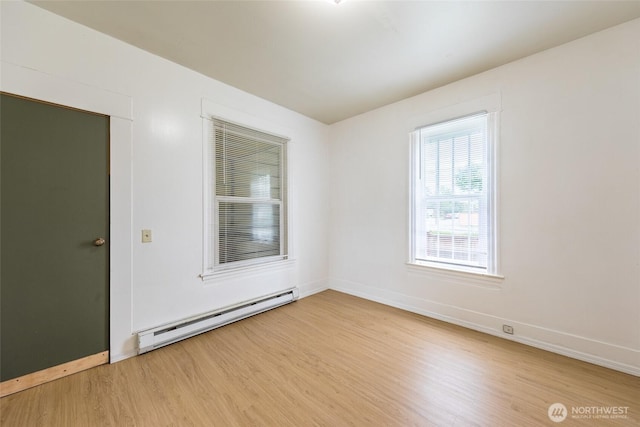 3827 S Morgan St, Seattle, WA 98118 - unfurnished room with a baseboard heating unit, wood finished floors, and baseboards