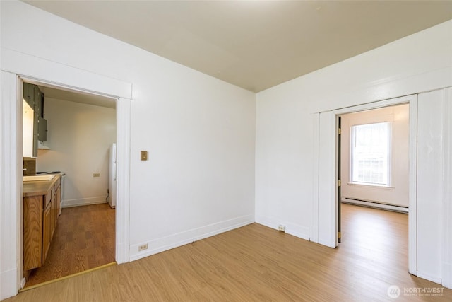 3827 S Morgan St, Seattle, WA 98118 - spare room featuring baseboard heating, light wood finished floors, and baseboards