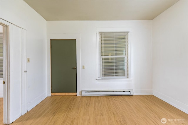 3827 S Morgan St, Seattle, WA 98118 - empty room with a baseboard radiator, wood finished floors, and baseboards