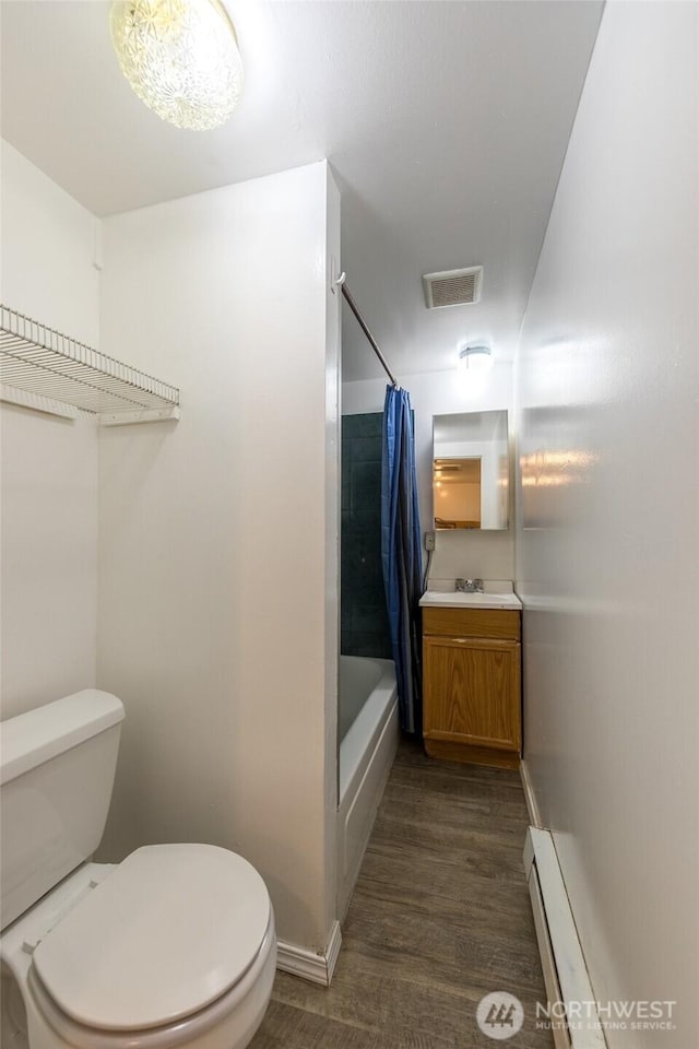 3827 S Morgan St, Seattle, WA 98118 - bathroom with toilet, vanity, shower / bath combination with curtain, wood finished floors, and baseboards