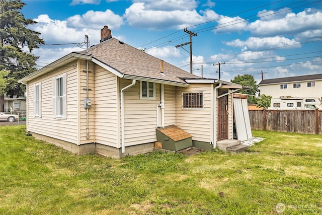 3827 S Morgan St, Seattle, WA 98118 - back of house with a chimney and roof with shingles