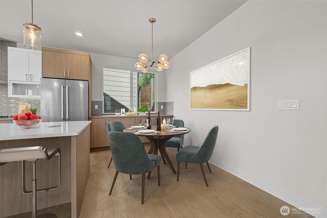 4570 22nd Ave SW, Seattle, WA 98106 - dining area with light wood-style flooring, a chandelier, baseboards, and recessed lighting