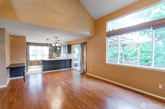 5614 Vincent Ct SE, Lacey, WA 98513 - unfurnished living room with a chandelier, wood finished floors, and healthy amount of natural light