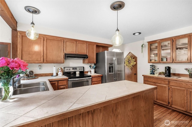 3904 Ridge Way, Mount Vernon, WA 98273 - kitchen with appliances with stainless steel finishes, under cabinet range hood, a sink, glass insert cabinets, and brown cabinets