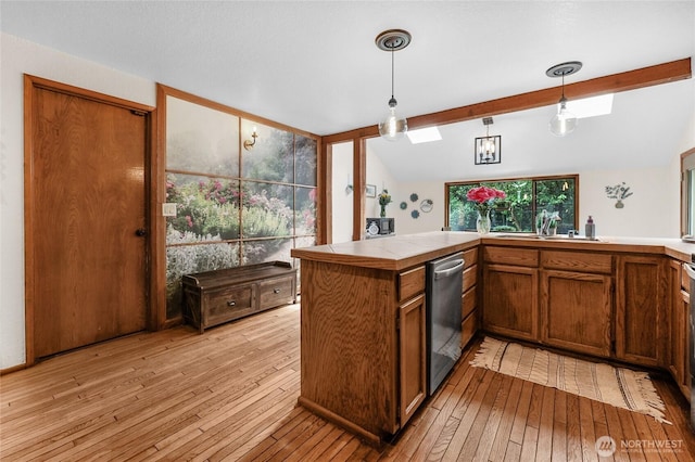 3904 Ridge Way, Mount Vernon, WA 98273 - kitchen with dishwasher, tile countertops, light wood finished floors, brown cabinetry, and hanging light fixtures