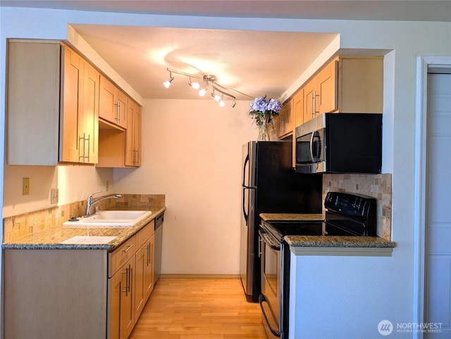 6960 California Ave SW Unit A104, Seattle, WA 98136 - kitchen with stainless steel appliances, light wood finished floors, and stone counters