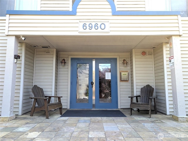 6960 California Ave SW Unit A104, Seattle, WA 98136 - property entrance featuring french doors and a patio area