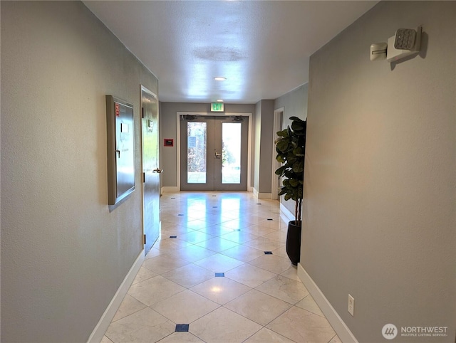 6960 California Ave SW Unit A104, Seattle, WA 98136 - corridor with french doors and light tile patterned floors
