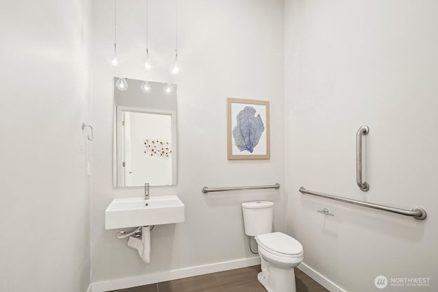 13329 1st Ave NE, Seattle, WA 98125 - half bath featuring baseboards, toilet, and a sink