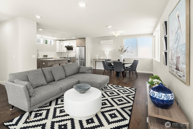13329 1st Ave NE, Seattle, WA 98125 - living area featuring dark wood-style floors, a wall mounted AC, recessed lighting, and baseboards