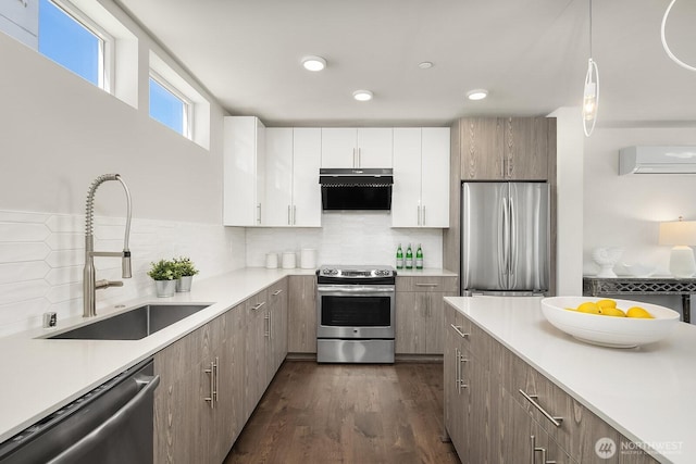 13329 1st Ave NE, Seattle, WA 98125 - kitchen with appliances with stainless steel finishes, a sink, range hood, a wall unit AC, and light countertops