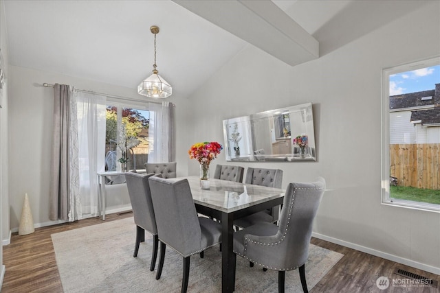 20111 74th Avenue Ct E, Spanaway, WA 98387 - dining space with wood finished floors, a chandelier, high vaulted ceiling, and baseboards